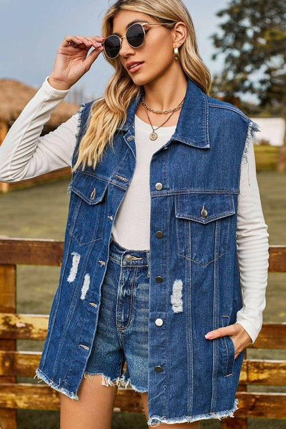 Denim cowgirl style distressed sleeveless top with pockets and collared neckline.