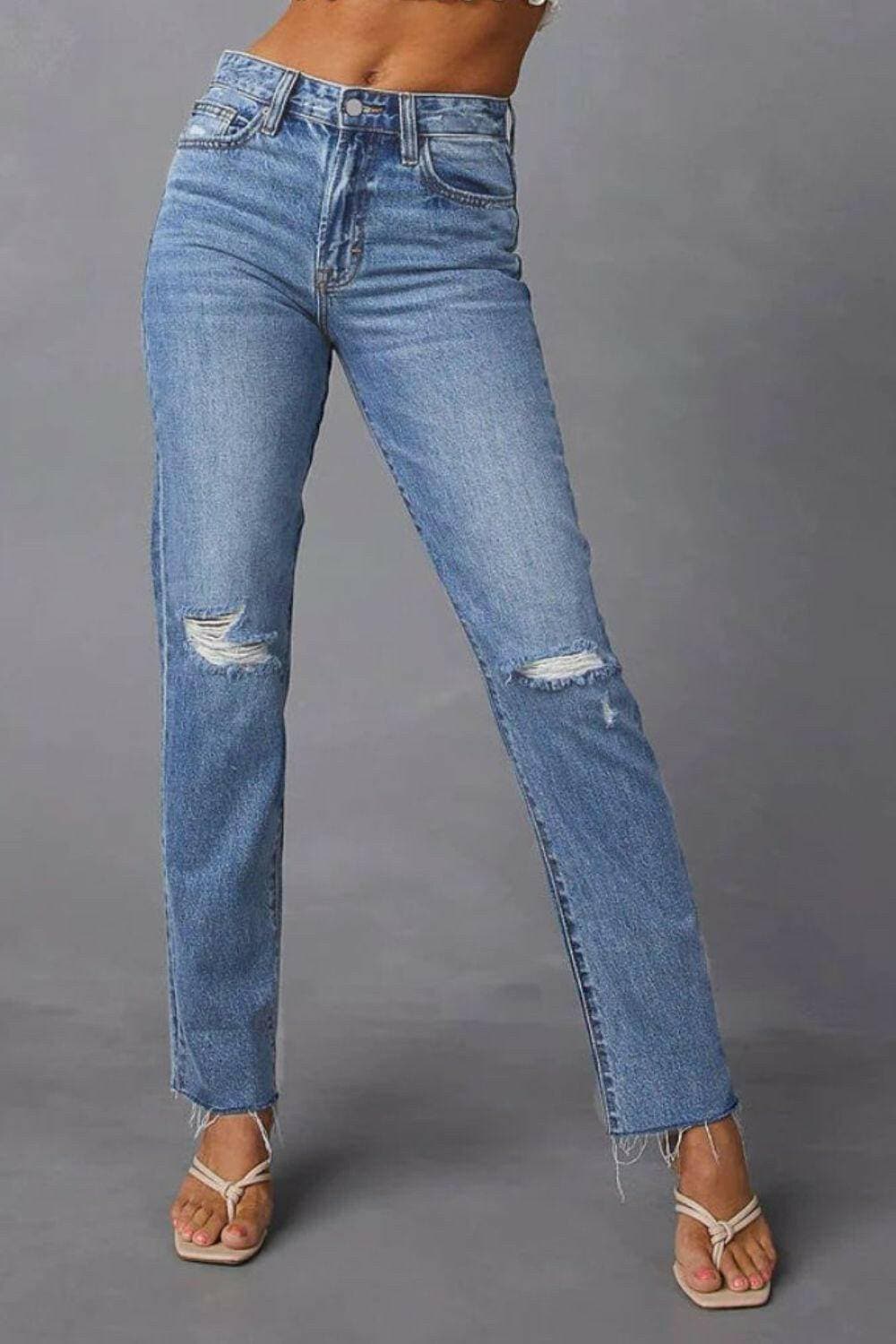 Chic distressed straight jeans with trendy raw hem and pockets