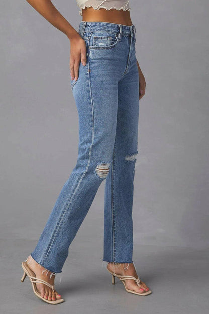 Chic distressed straight jeans with trendy raw hem and pockets