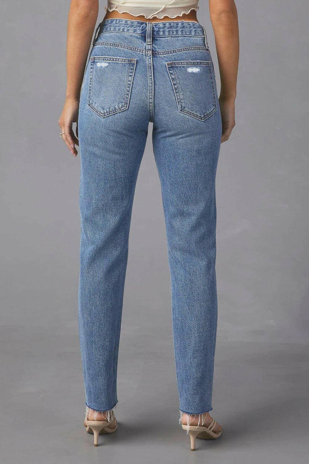 Chic distressed straight jeans with trendy raw hem and pockets