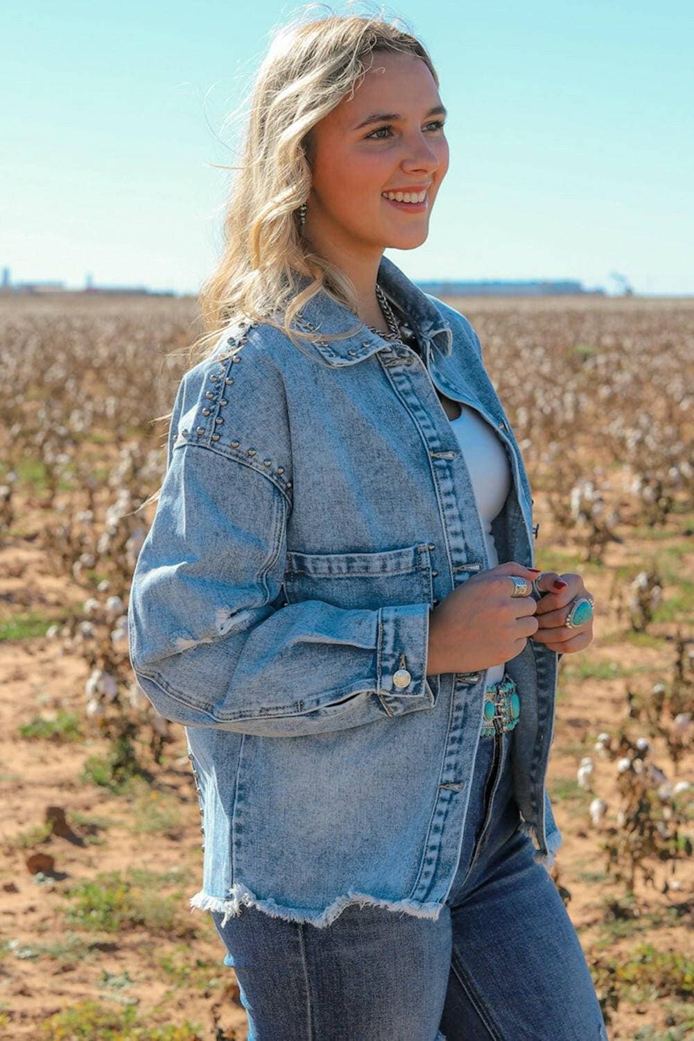 Edgy studded denim jacket with raw hem and button detail