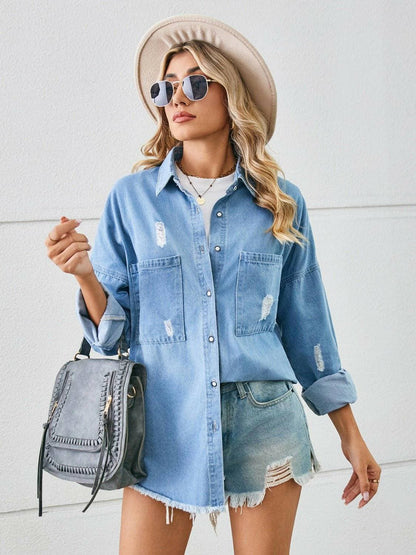 Urban Edge distressed denim jacket with dropped shoulders and raw hem detailing, worn by a person with sunglasses and a hat.