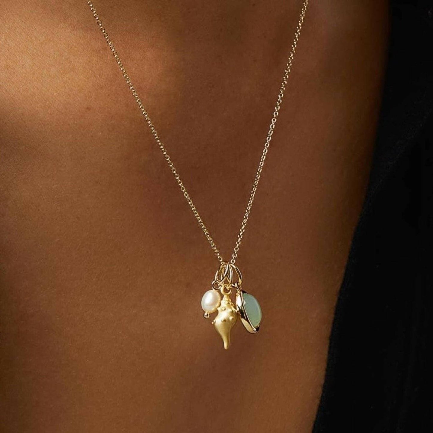 Elegant crystal conch necklace with 14K gold-plated finish.