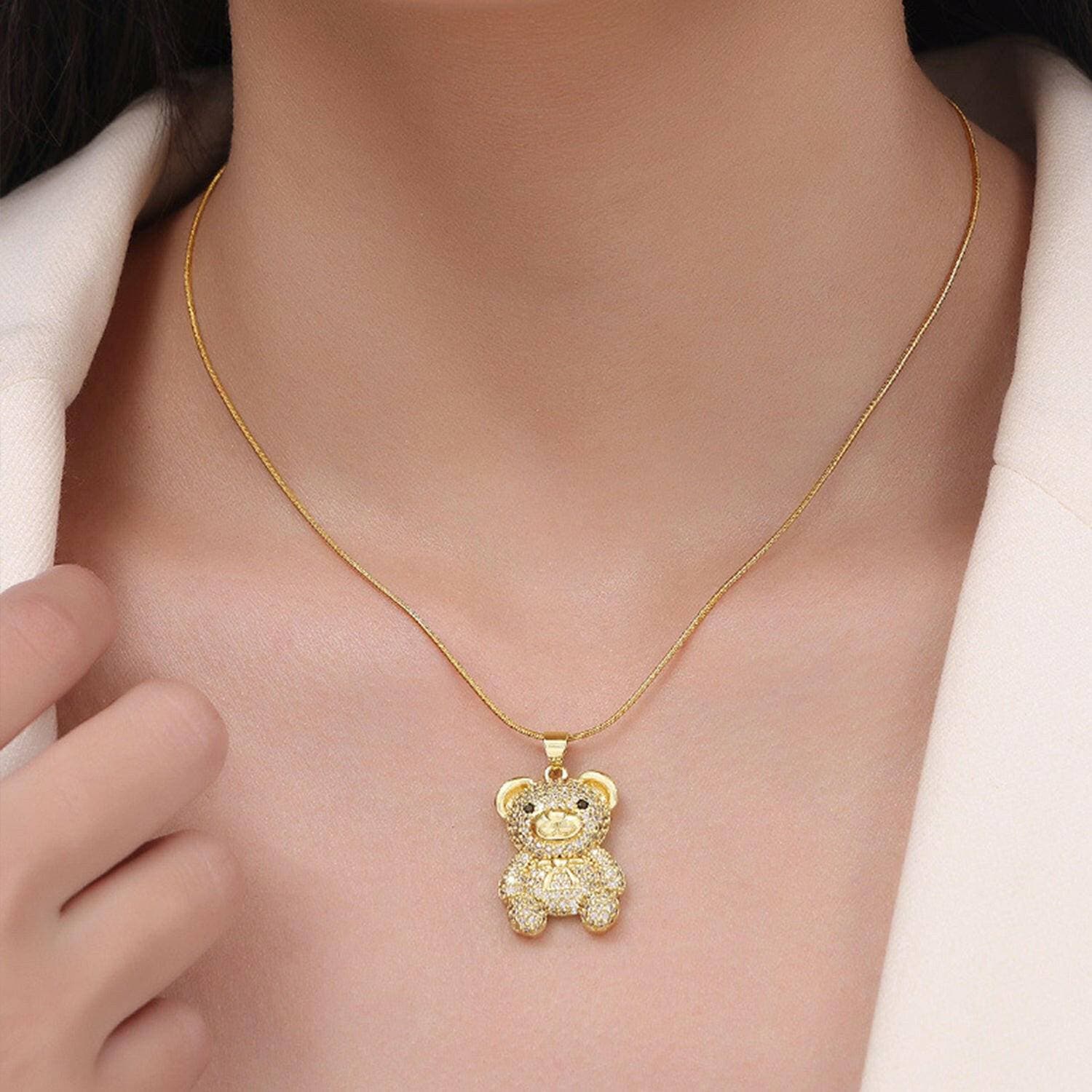 Bear Pendant Necklace with Gold-Plated Titanium Steel and Zircon DetaiBear Pendant Necklace with Gold-Plated Titanium Steel and Zircon Detailing
 Make a Bold Statement with Elegance and Style
 Key Features:
 
 
Durable Material: CrafteLove Salve Bear Pendant NecklaceJewelry