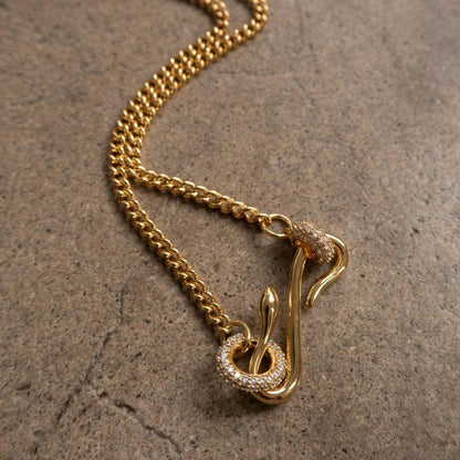 Luxurious 18K gold-plated copper zircon necklace on a textured surface.