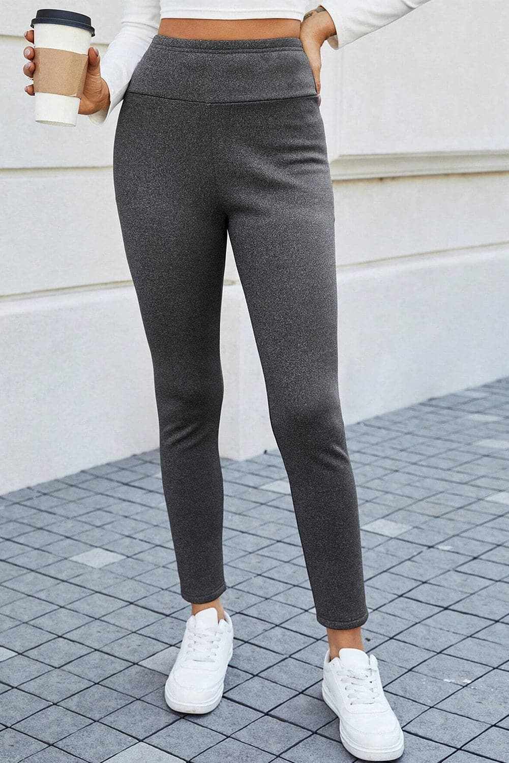High-rise stretchy leggings in gray, showcasing comfortable fit and exceptional flexibility, paired with white sneakers.
