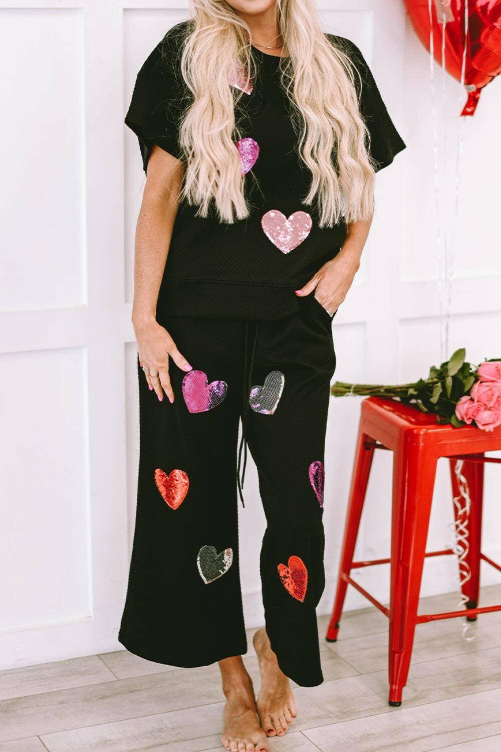 Sequin Heart Detail Cozy Lounge Suit with Short Sleeve Top and AdjustaStand out in Style and Comfort
 Elevate your loungewear collection with our Sequin Heart Detail Cozy Lounge Suit. This two-piece set is designed to make you feel chiLove Salve Sequin Heart Detail Cozy Lounge Suitlounge