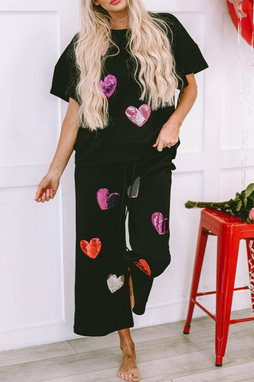 Sequin Heart Detail Cozy Lounge Suit with Short Sleeve Top and AdjustaStand out in Style and Comfort
 Elevate your loungewear collection with our Sequin Heart Detail Cozy Lounge Suit. This two-piece set is designed to make you feel chiLove Salve Sequin Heart Detail Cozy Lounge Suitlounge