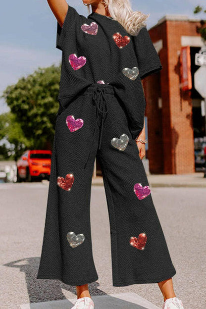 Sequin Heart Detail Cozy Lounge Suit with Short Sleeve Top and AdjustaStand out in Style and Comfort
 Elevate your loungewear collection with our Sequin Heart Detail Cozy Lounge Suit. This two-piece set is designed to make you feel chiLove Salve Sequin Heart Detail Cozy Lounge Suitlounge