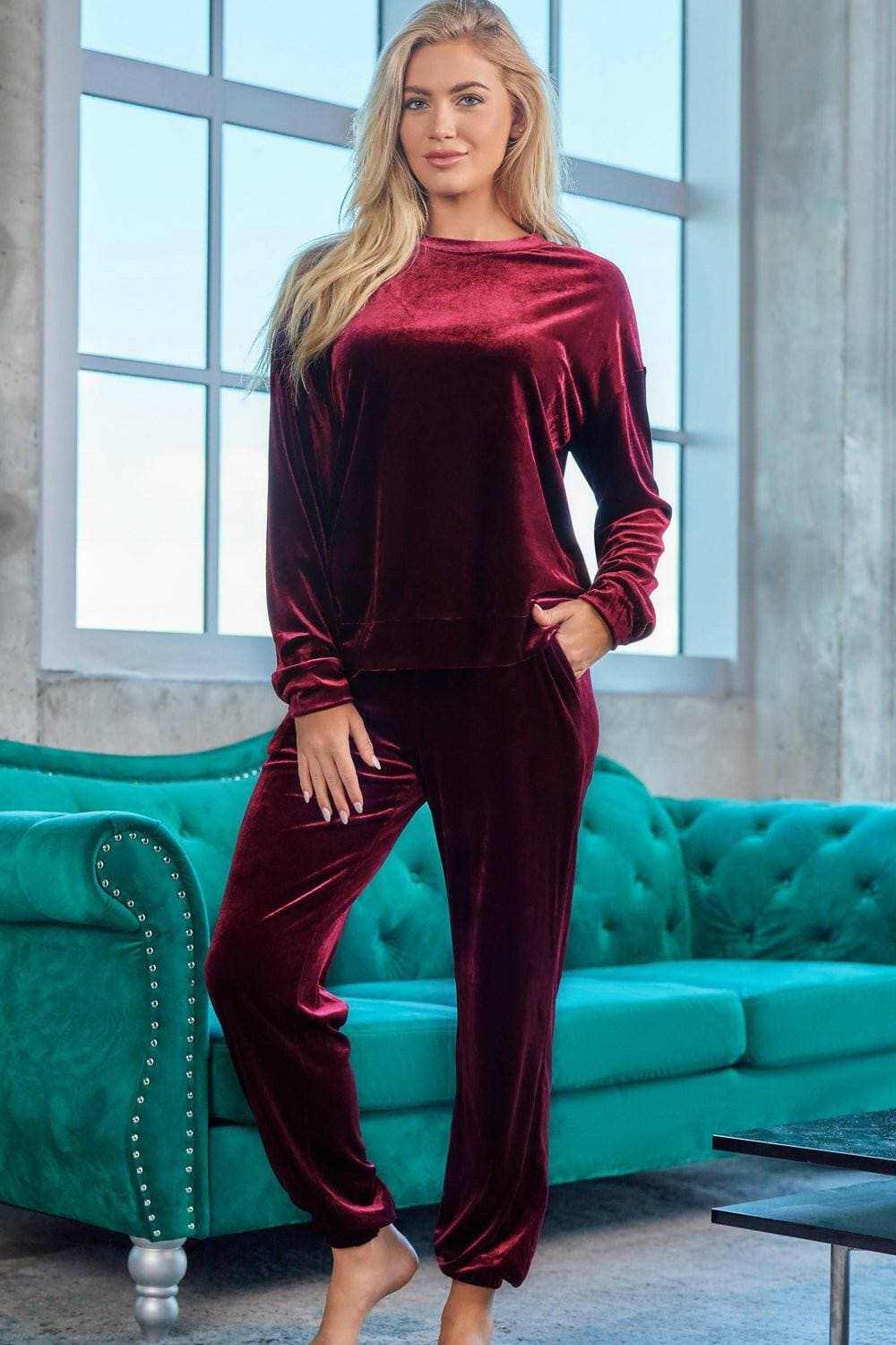 Chic two-piece lounge set with velvet finish, featuring a coordinated top and bottom in a rich burgundy color.