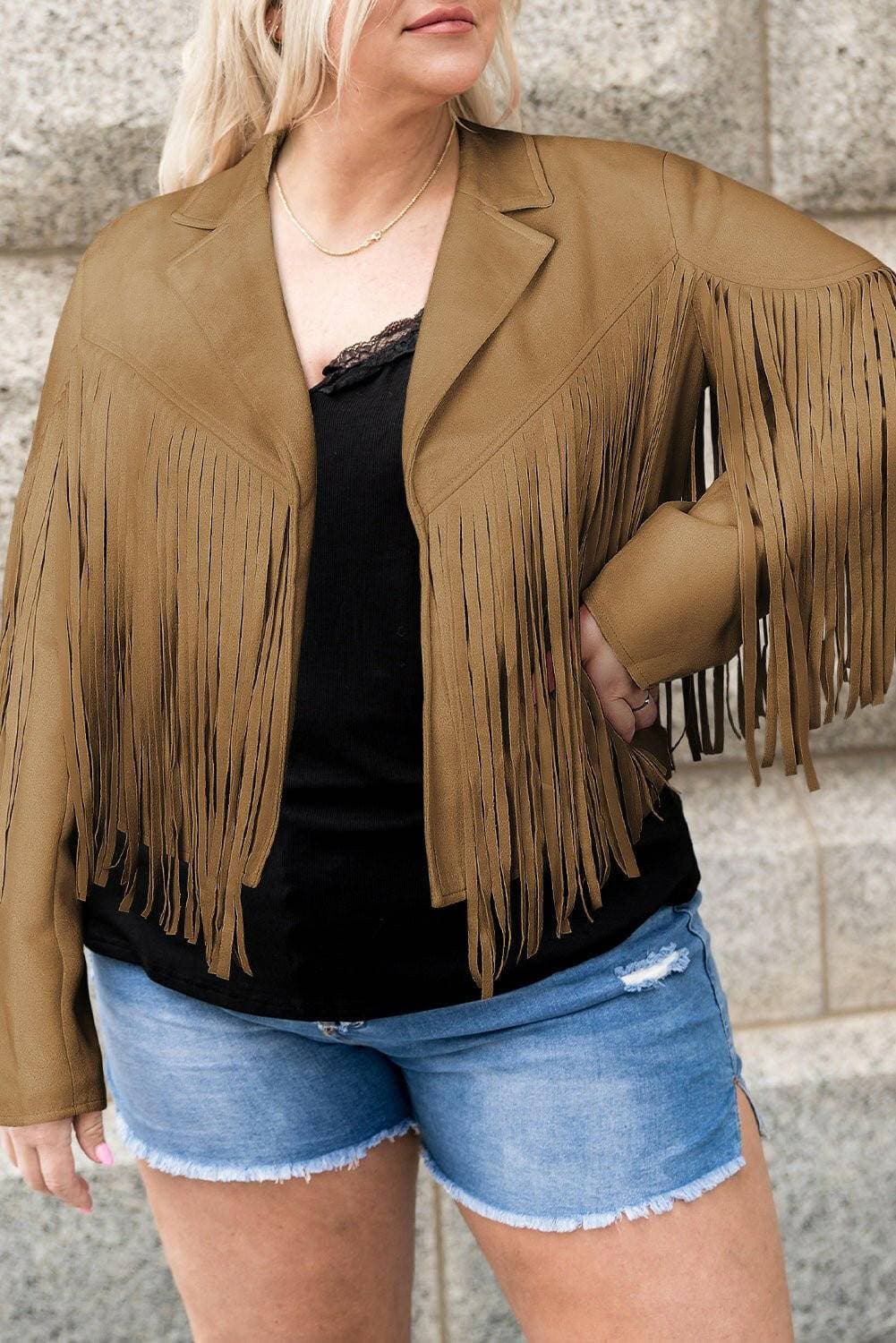 Fringed open plus size jacket in brown paired with black top and denim shorts.