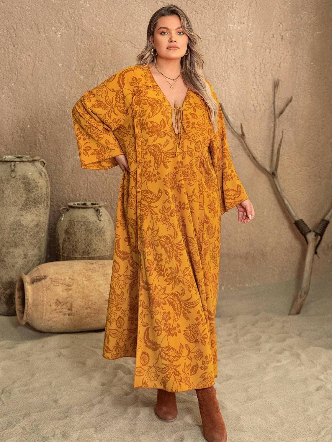 Elegant plus size dress with slit, long sheer sleeves, designed for curves and versatile style.