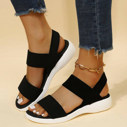 Open toe rubber low heel sandals in black with adjustable straps.