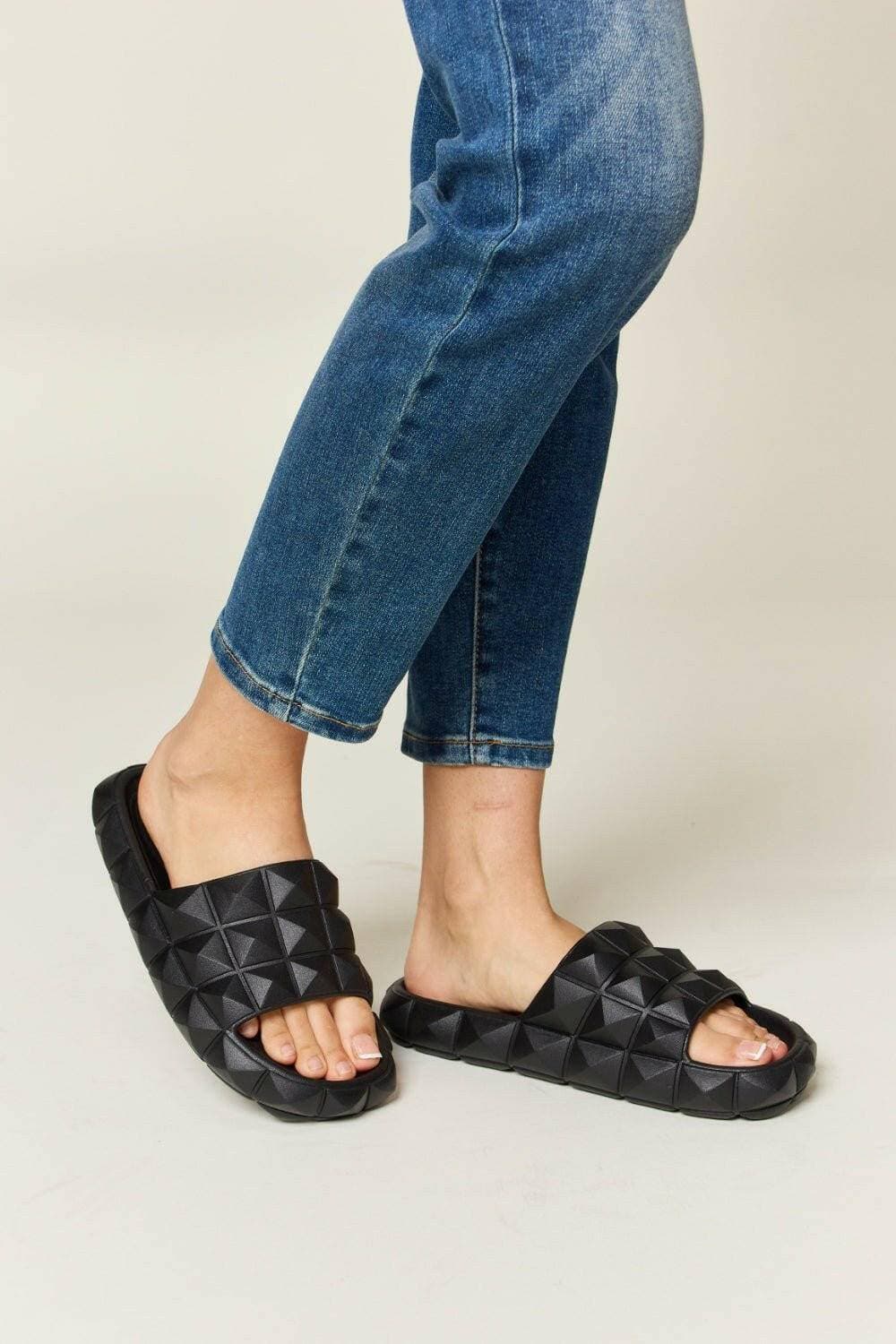 Edgy pyramid stud toe band sandals with bold design and comfortable fit.