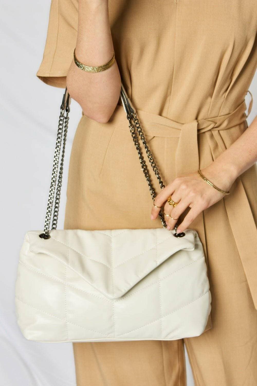 Luxurious Faux Leather Handbag with Chain StrapExperience Elegance and Sustainability
 Luxurious Appeal: Elevate your look with this sophisticated faux leather handbag that exudes luxury and style.
 
 SustainableLove Salve Luxurious Faux Leather HandbagShoes