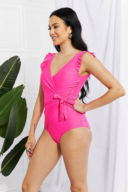 Chic pink ruffle wrap swimsuit with elegant tie and frilly straps